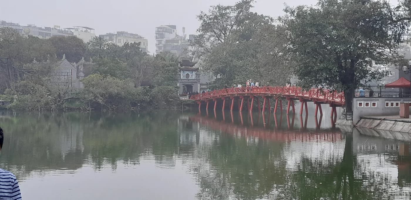 The red The Huc Bridge over Hoan Kiem Lake, photographed in 2025