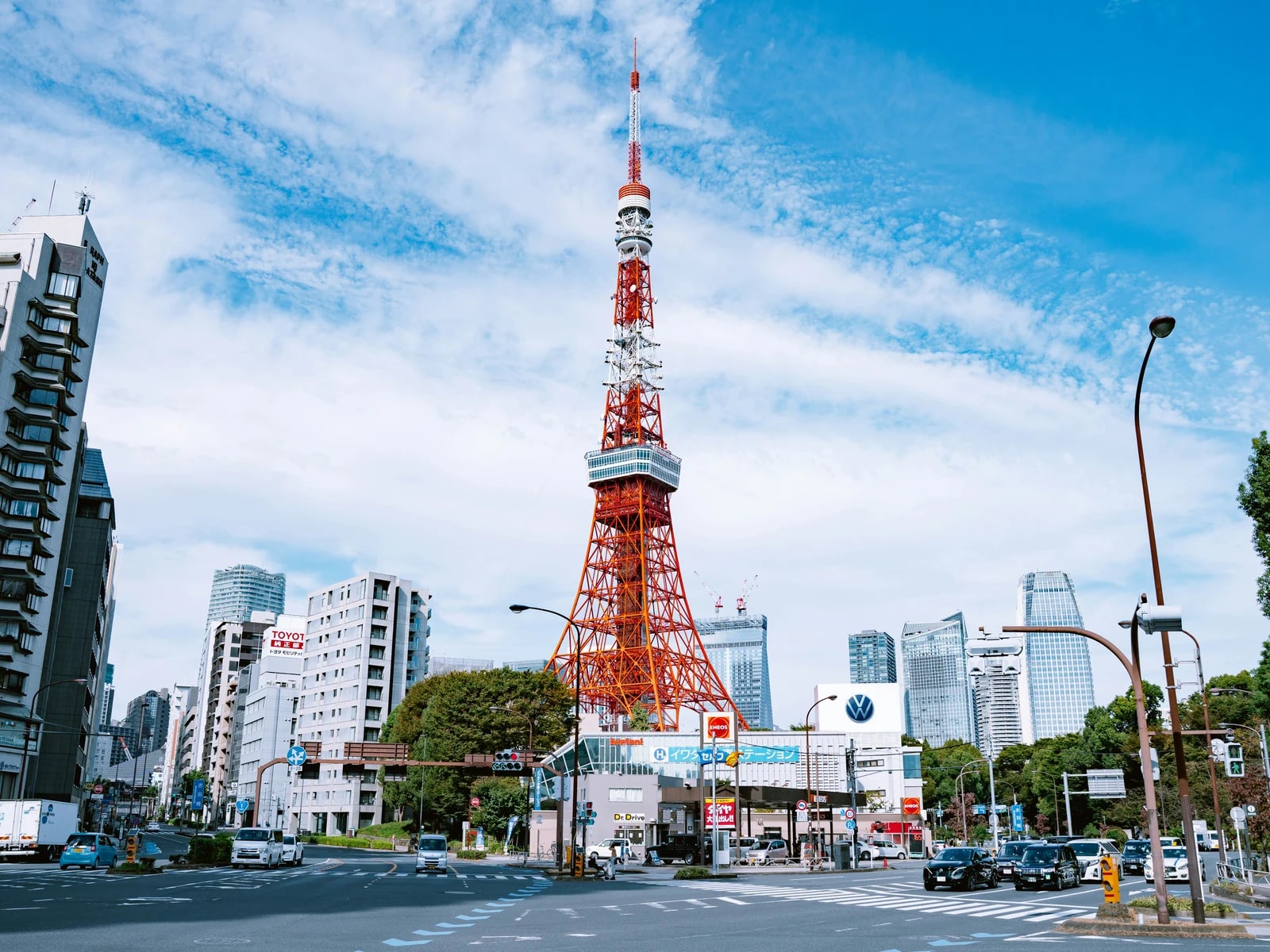 Tokyo Tower above green trees under a blue sky