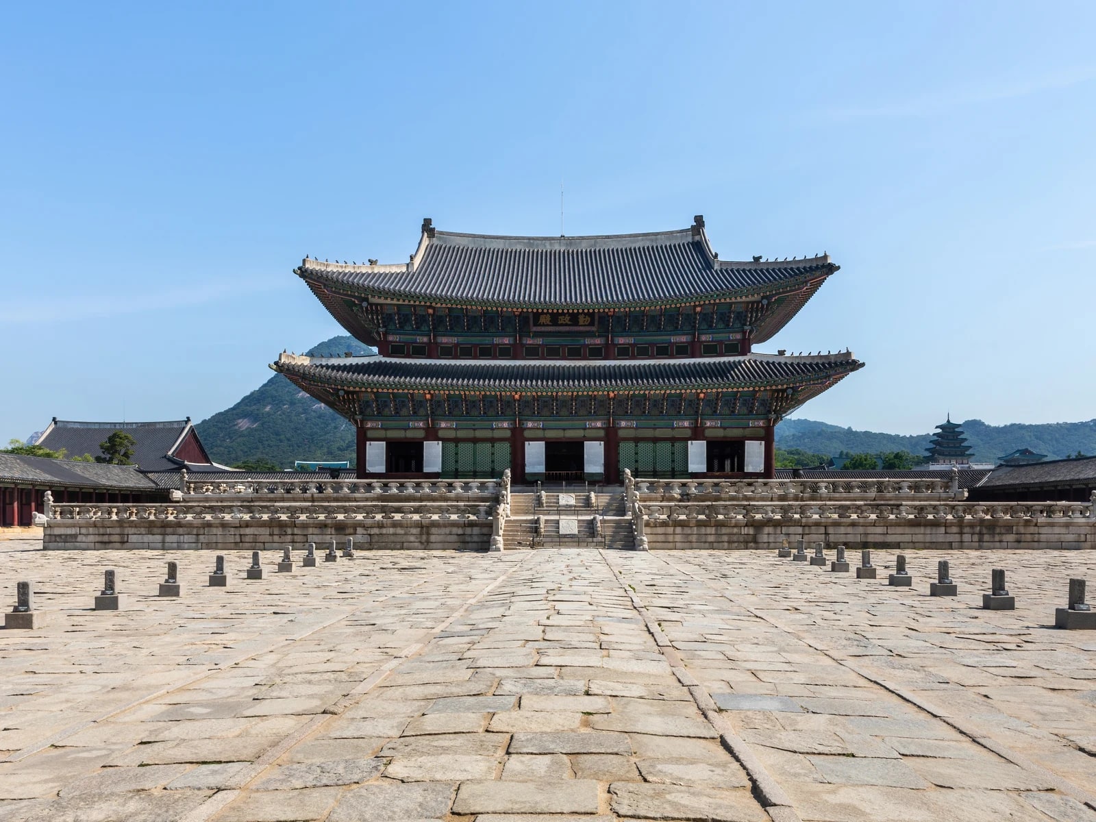 Geunjeongjeon throne hall at Gyeongbokgung Palace in Seoul beneath a blue sky